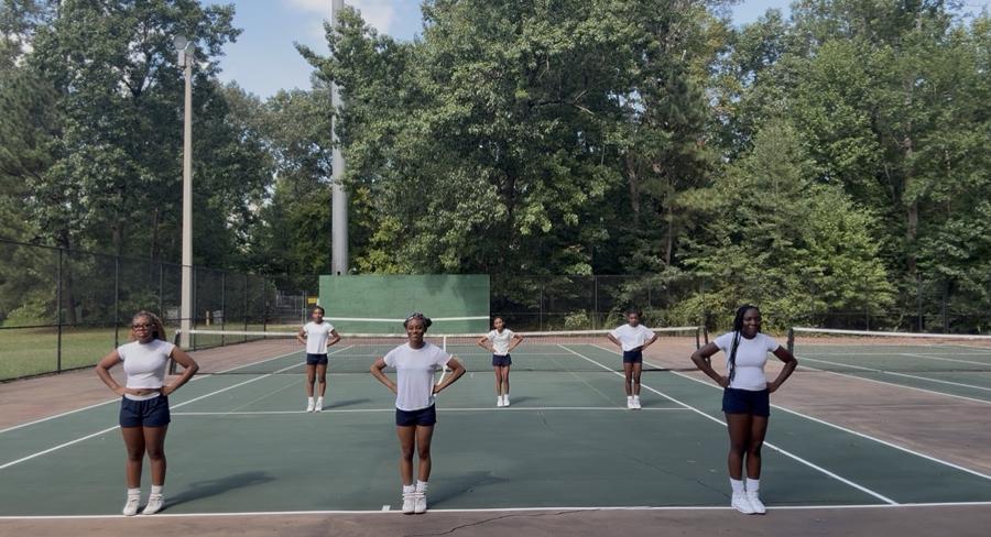 Athletes standing in formation with hands on hips, ready to start