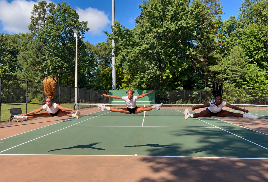 Three athletes mid-air in toe-touch jumps
